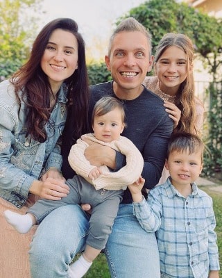 Karolina Protsenko posing with her family members by wearing beautiful dress.